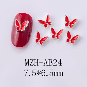 Detailed view of 7.5x6.5mm red alloy butterfly nail charms with oil dripping effect