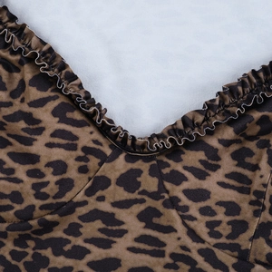 Macro detail of leopard print fabric with ruffle trim and fine textile texture