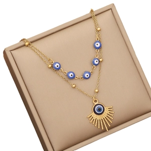 Double-layered gold stainless steel necklace with blue evil eye beads in a gift box