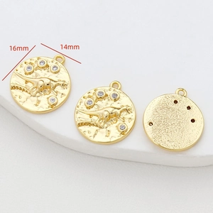 Detail of 14K gold plated dinosaur fossil pendant with zirconia stones for DIY jewelry