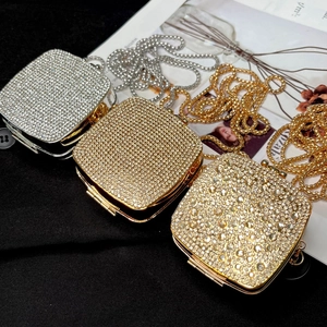 Close-up of sparkling gold and silver rhinestone mini bags with elegant metal chain straps