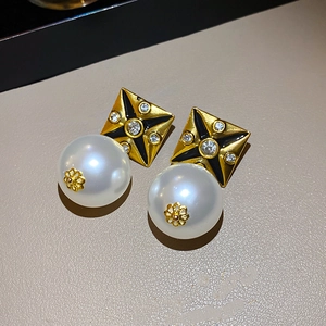 Detail of vintage diamond square earrings with black starburst and white pearls
