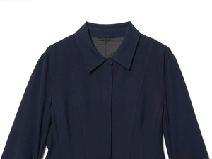 Detailed view of navy blue dress shirt with hidden placket and pointed collar stitching
