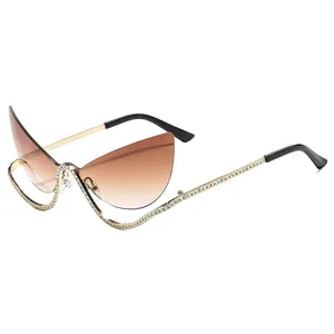 Fashionable inverted cat eye sunglasses with gold metal frame and rhinestone trim