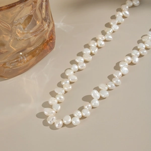 Detailed view of white natural baroque freshwater pearl necklace with unique textures