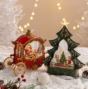 Close-up of Santa Claus snow globes featuring a red carriage and green tree on snow