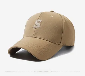 Detail view of khaki baseball cap featuring 3D S-letter embroidery and cotton fabric