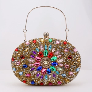 Close-up of gold rhinestone evening clutch with colorful gems and metal handle ring