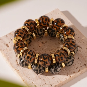Vintage leopard acrylic beaded stretch bracelet with golden metal spacers on stone base