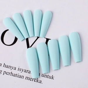 Close-up of matte light blue ballerina shape press-on nails with a frosted texture