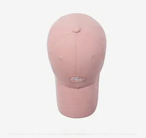 Top down view of pink cotton baseball cap crown with embroidered patch detail