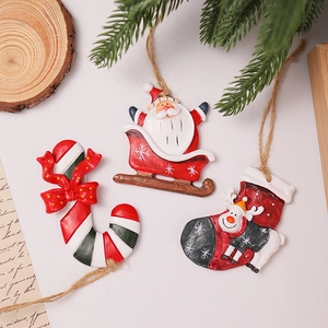 Macro shot of resin Santa sleigh and reindeer ornaments on rustic wood and pine needles