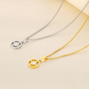 Detail of gold and silver hollow geometric round pendants with clear center crystals