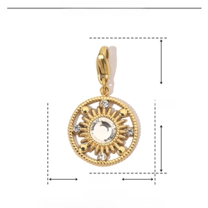 Macro detail of gold sunburst pendant with sparkling rhinestones and lobster clasp
