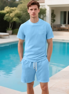 Close-up of light blue waffle knit fabric on men's summer t-shirt and drawstring shorts