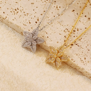 Primo piano squisito di pendenti floreali con zirconi in placcatura argento e oro