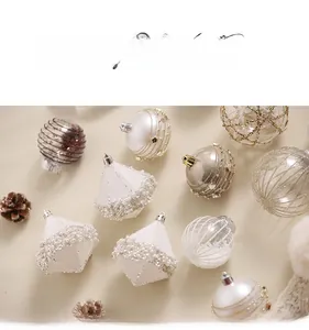 Detailed view of champagne and pearl white Christmas ornaments with glitter finish