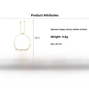 Detail view of gold heart bracelet with white shell, zircon inlay and adjustable slide clasp