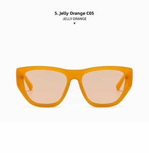 Détail de lunettes de soleil carrées orange gelée avec plaquettes intégrées et verres clairs