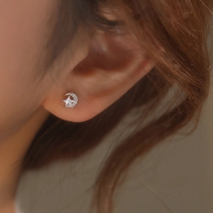 Sparkling S925 sterling silver moon and star stud earrings with cubic zirconia on ear
