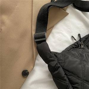 Classic black quilted crossbody bag with diamond pattern and adjustable shoulder strap