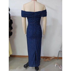 Detail of navy off-shoulder dress featuring silver glitter mesh and ruched back slit