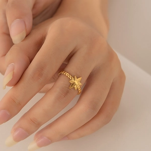Close-up of gold plated North Star ring featuring a unique beaded band design on finger