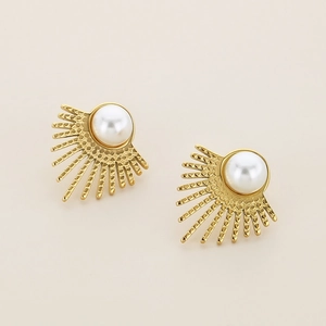 Close-up of golden sunburst stud earrings featuring elegant white pearls on a soft background
