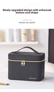 Close-up of black cross-grain leather makeup case with gold zipper and handle detail