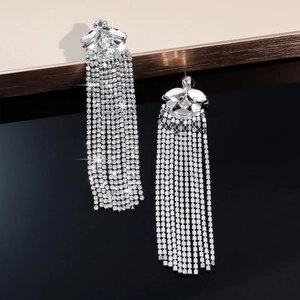 Macro detail of silver tassel earrings with sparkling crystals for evening wear