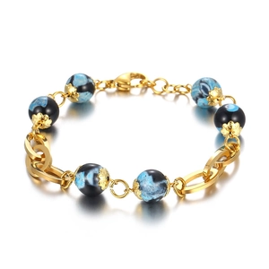 Gold hollow lip charm bracelet with blue-black swirl resin beads and stainless steel link chain