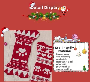 Detail of knitted bone-shaped Christmas stockings with heart and paw patterns in red and white