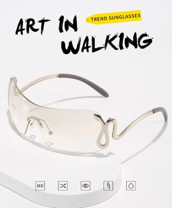 Detail of rimless sunglasses with tan gradient lenses and gold snake-shaped metal temples