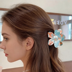 Vintage acrylic flower hair claw with blue pink marble pattern on female model