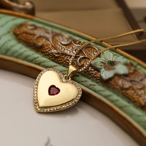 Detailed view of red heart crystal pendant with gold plating and cubic zirconia halo