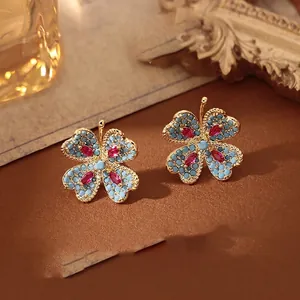 Boucles d'oreilles trèfle vintage avec pierres bleues et zircon rouge doré