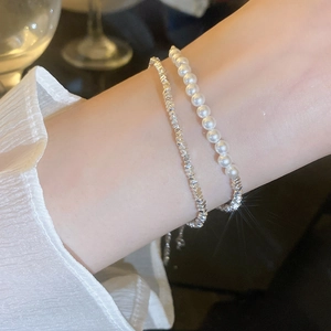 Detail of elegant double-layer bracelet with pearls and faceted silver beads on wrist