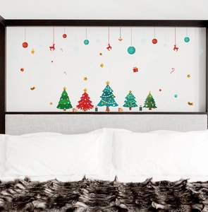 Cozy bedroom setting with PVC Christmas wall decals featuring reindeer and trees
