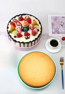 Macro detail of pink and mint green silicone cake molds on marble with a baked cake