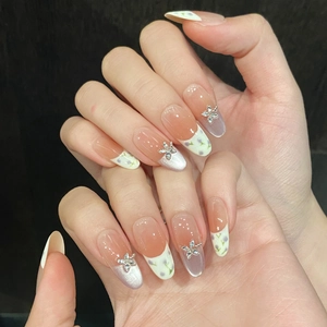 Handmade gradient pink press-on nails with purple floral patterns and crystal accents