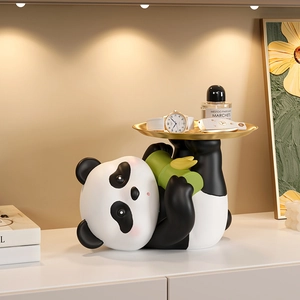 Cute panda figurine with golden tray for key and accessory storage in home entryway