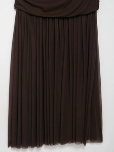 Detailed close-up of brown tiered mesh fabric with vertical pleats and layered design
