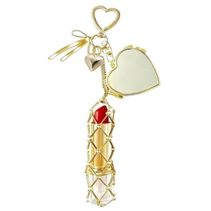 Detailed view of hollow golden metal lipstick holder keychain with heart mirror