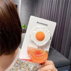 Creative resin hair clips in fried egg and tomato slice shapes for quirky hairstyling