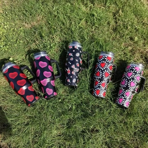 Outdoor view of 40oz stainless steel heart pattern travel mugs with handles