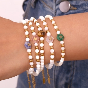 Detailed close-up of multilayered beaded bracelet with shell pearls and colorful natural stones