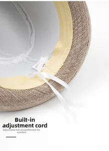 Detail of adjustable inner sweatband and sizing cord inside the straw sun hat