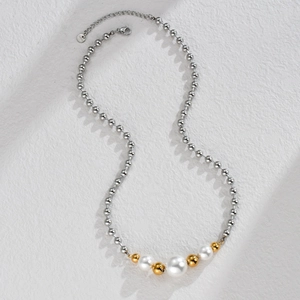 Detail of stainless steel bead necklace with pearls and S.Steel engraved tag