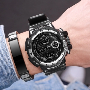 Waterproof sports digital watch with large black dial and silicone strap on male wrist