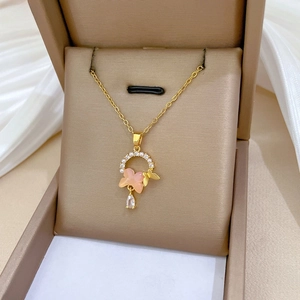 Detail of gold butterfly necklace with pearls and crystal pendant in a gift box